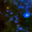 A star field containing myriad green stars and a dozen or more stars surrounded by blue fields.