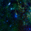 2 galaxies in a star field, with clouds of colored dust