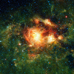 Green and yellow gasses along with many white dots makeup the NGC 3603 nebula.