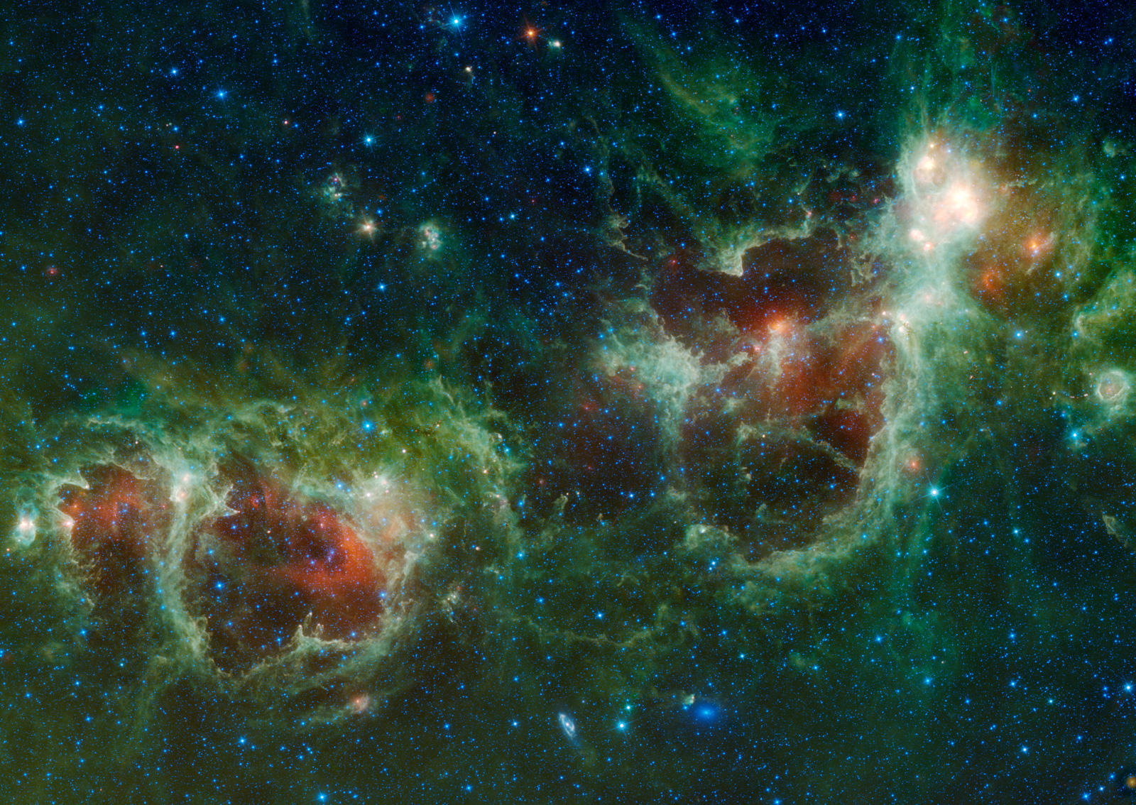Two distinct multicolored clouds are visible.  The one on the right, which resembles a human heart, is called the Heart Nebula and the one on the left is called the Soul Nebula.