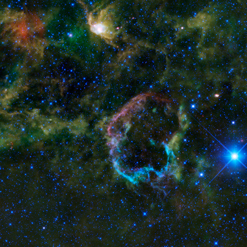 The violet and cyan colored clouds make up the Jellyfish Nebula.