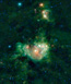 A field of blue and cyan stars, with red and green wispy nebula at center.