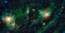A field of blue and cyan stars, with red and green wispy nebula at center.