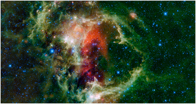 WISE mosaic of the Soul Nebula.  Clouds of all colors surround clusters of stars.