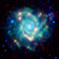 A glowing blue/white pinwheel-shaped galaxy in a field of stars.