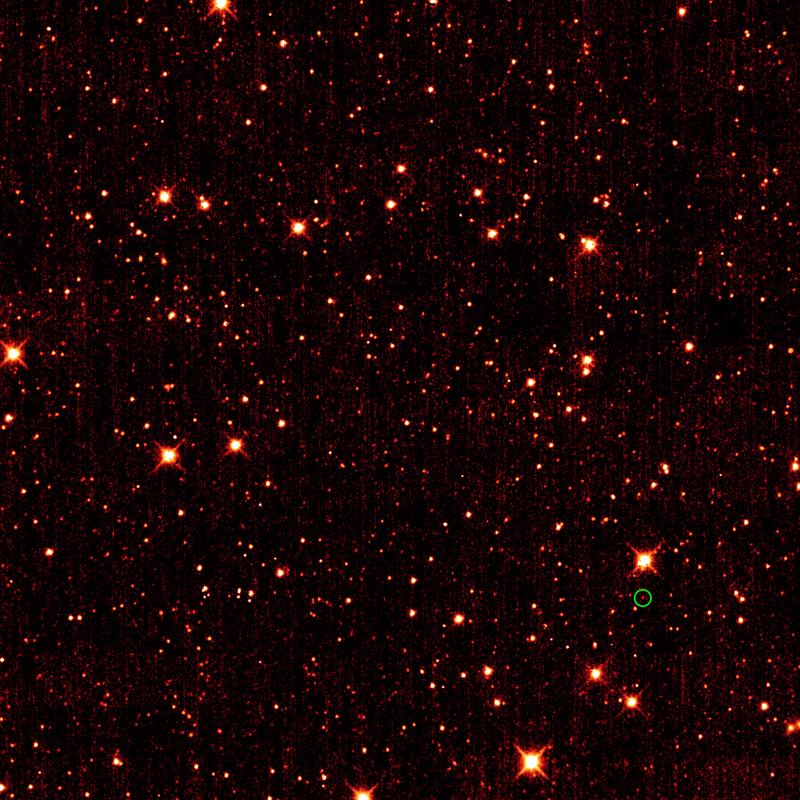 A reddish star field with one star in lower right circled in green.