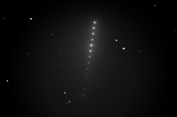 Space is shown with many bright dots in a line indicating the comet's path.